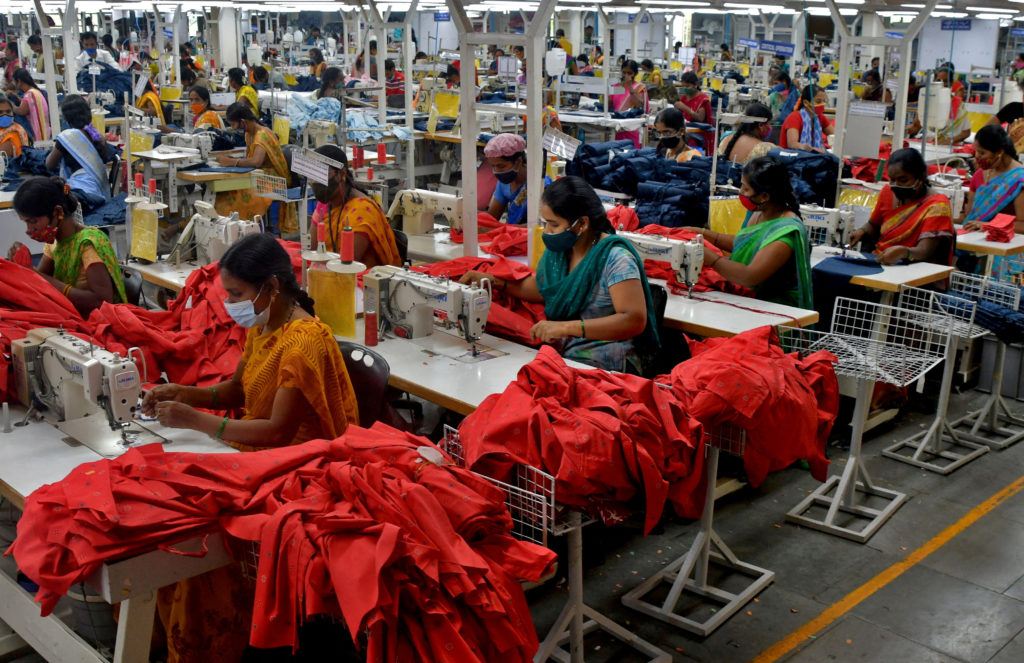 FILE PHOTO: FILE PHOTO: Garment workers stitch shirts at a textile factory in Hindupur, Andhra Pradesh, India