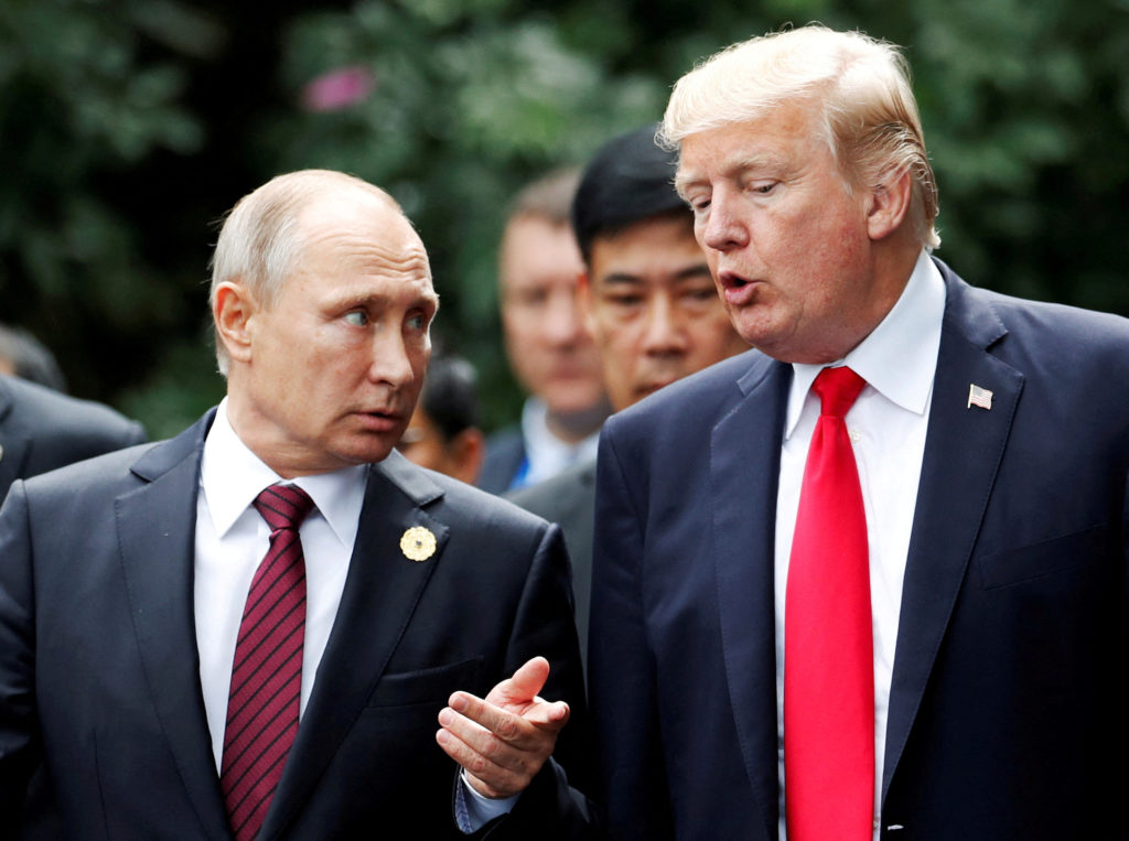 FILE PHOTO: FILE PHOTO: U.S. President Donald Trump and Russia's President Vladimir Putin talk during the family photo ses...