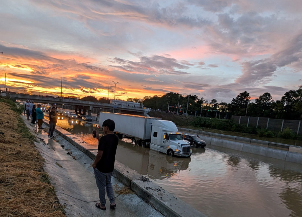 Vehicles stand on a flooded road, in Chattanooga
