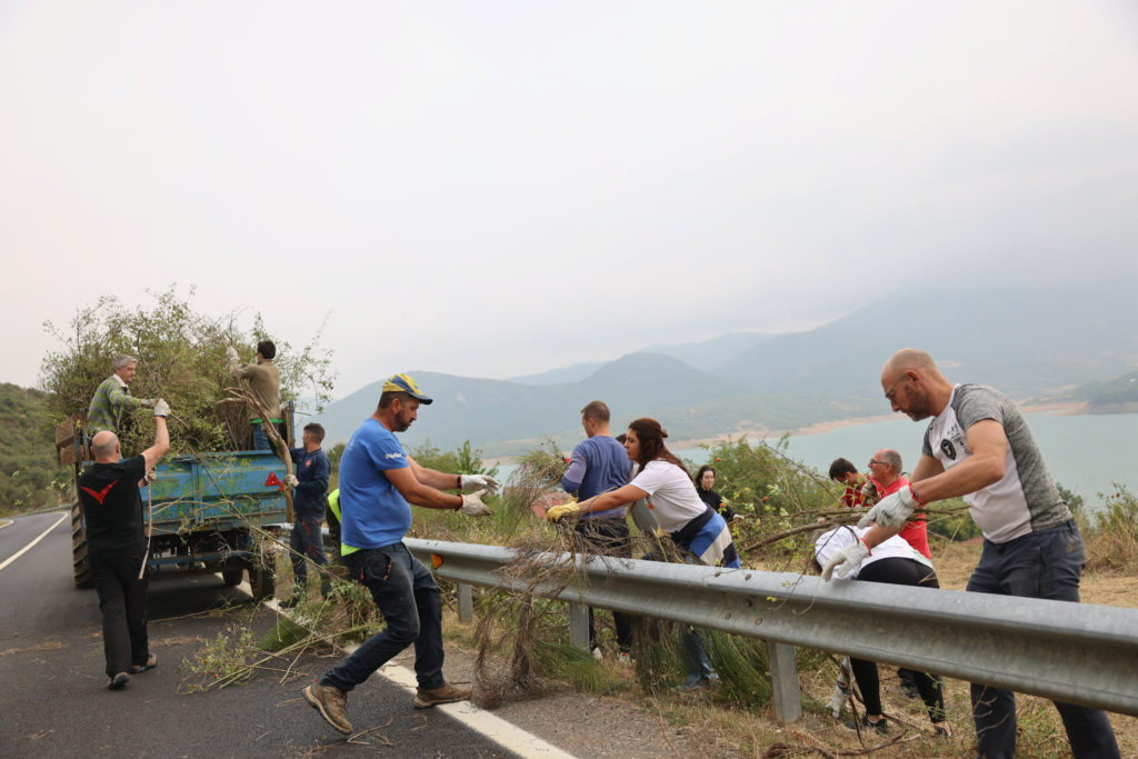 Residents clear bushes and vegetation to prevent wildfires from reaching the village of Riano