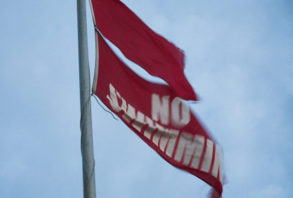 Hurricane Erin whips up strong winds and some flooding as it slowly moves further out to sea