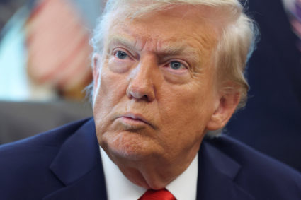 U.S. President Donald Trump signs executive orders in the Oval Office at the White House in Washington