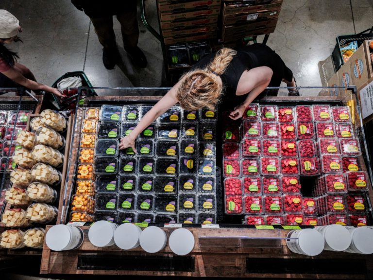 FILE PHOTO: People shop for groceries at a store in New York City