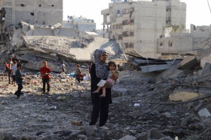 Palestinians inspect the site of an overnight Israeli strike on a house, in Gaza City
