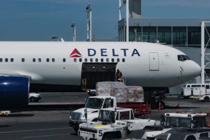 A staff uploads packages on Delta Air Lines plane at John F. Kennedy International Airport in Queens, New York City