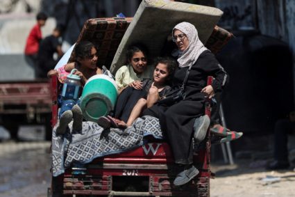Displaced Palestinians make their way as they flee amid an Israeli military operation, in Gaza City