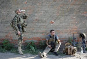 Servicemen of the National Guard of Ukraine rest as they return from a combat mission in Kharkiv region