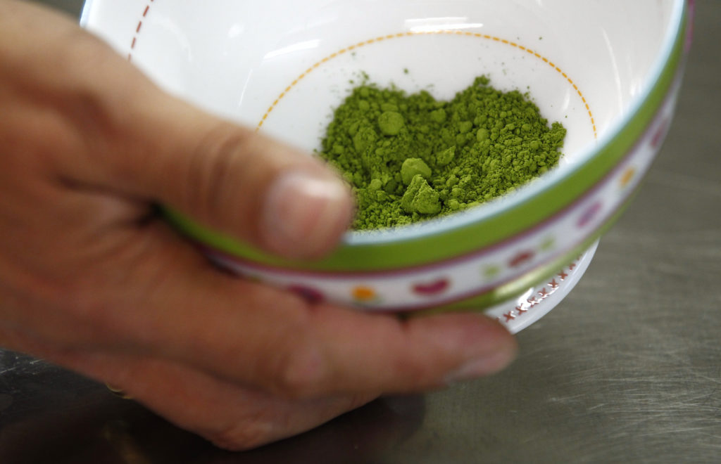 Green Japanese matcha tea powder is seen as butcher Hinterberger prepares to make special green tea variation of the 'weis...