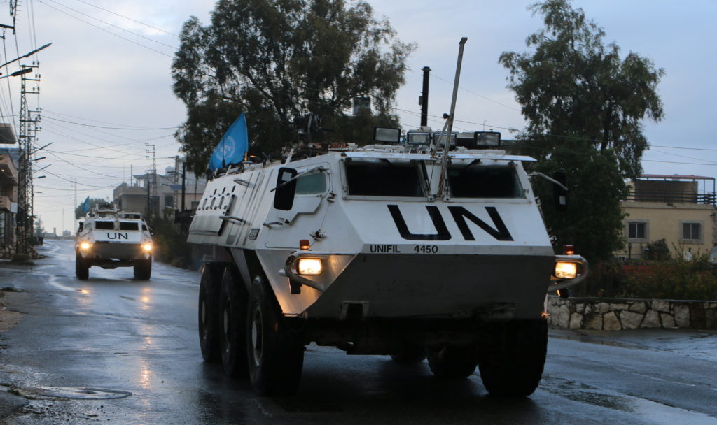 UN peacekeepers (UNIFIL) vehicles ride along a street amid ongoing hostilities between Hezbollah and Israeli forces, in Ma...