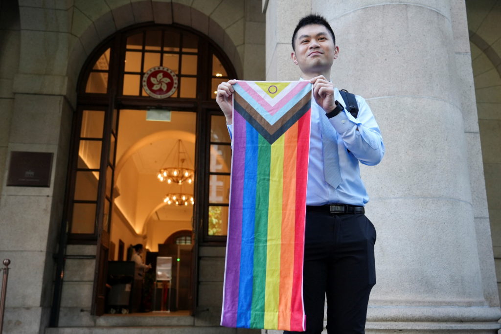 Nick Infinger holds intersex-inclusive pride progress flag after Hong Kong's top court rules in favour of equal housing an...