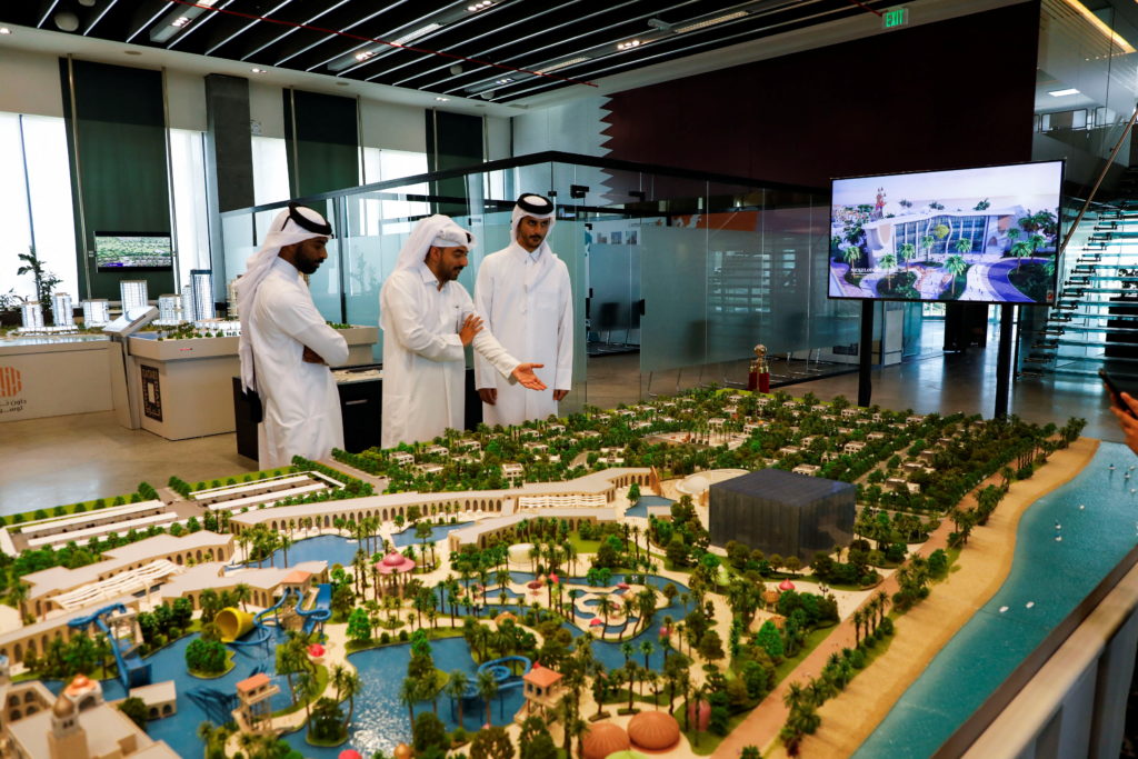 Locals look at the 3D model of Trump International Golf Club & Trump Villas project launched between Qatar Diar and Da...