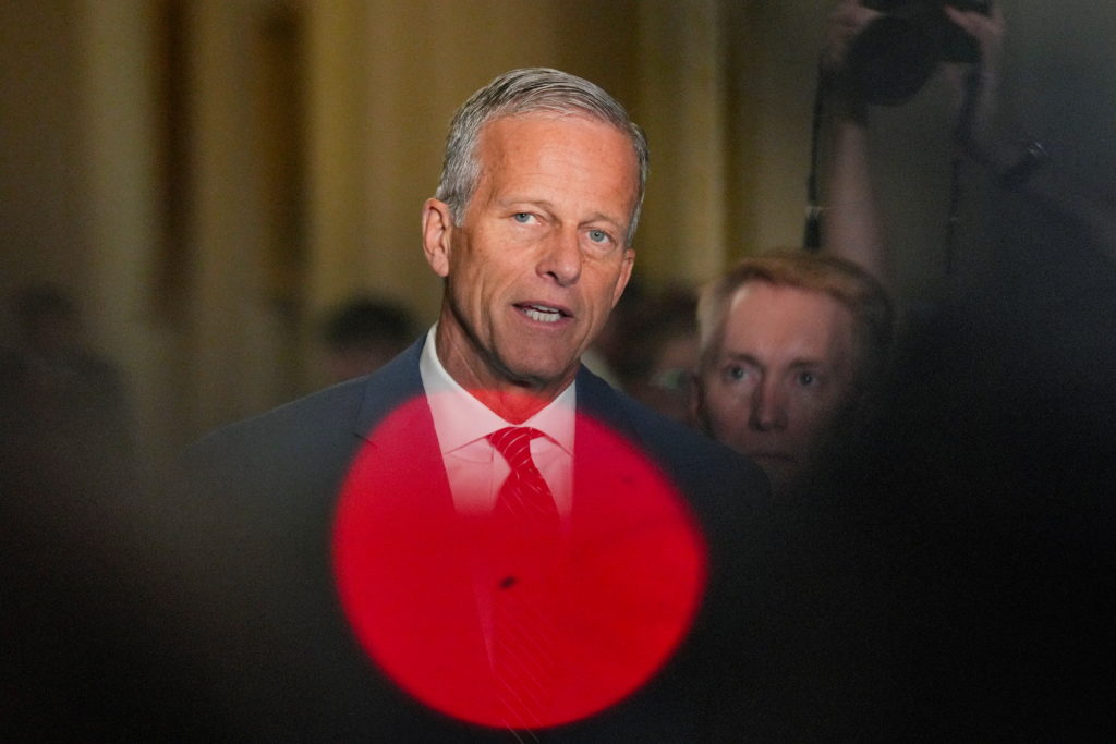 Senate Majority Leader John Thune, R-S.D., talks to reporters after a July policy luncheon meeting on Capitol Hill. A red ...