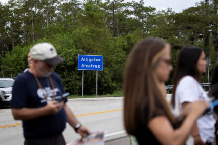 People attend a vigil at the entrance of "Alligator Alcatraz" ICE detention center in Ochopee