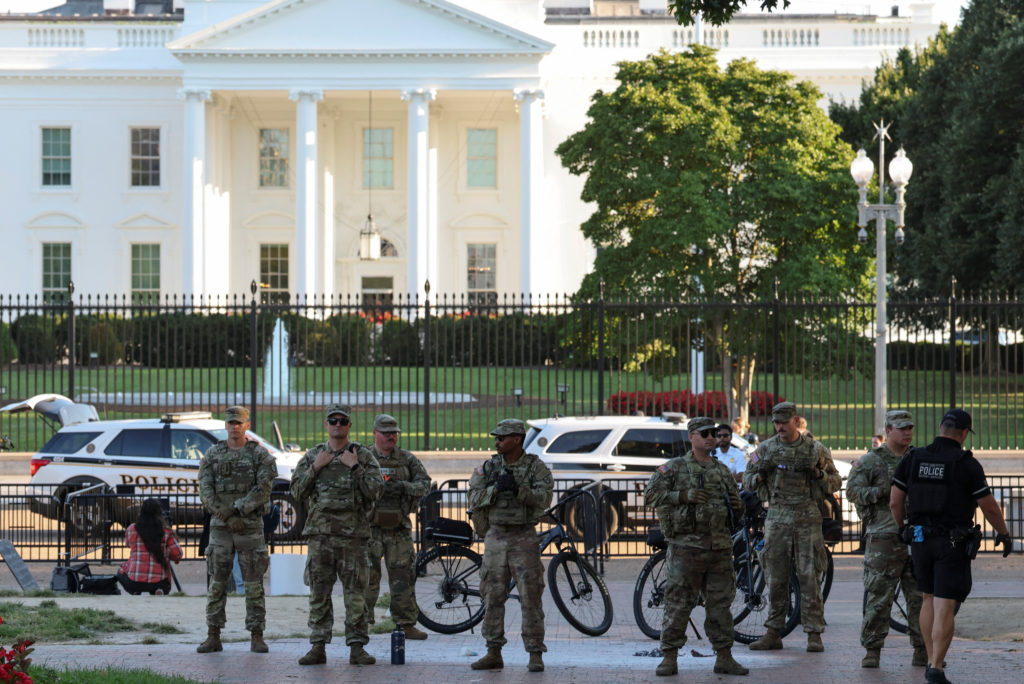 U.S. Army National Guard soldiers surround the scene where a man burned a U.S. flag at the edge of Lafayette Park across f...