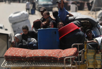 Displaced Palestinians make their way as they flee amid an Israeli military operation, in Gaza City