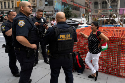FILE PHOTO: A migrant is detained by federal immigration officers at U.S. immigration court