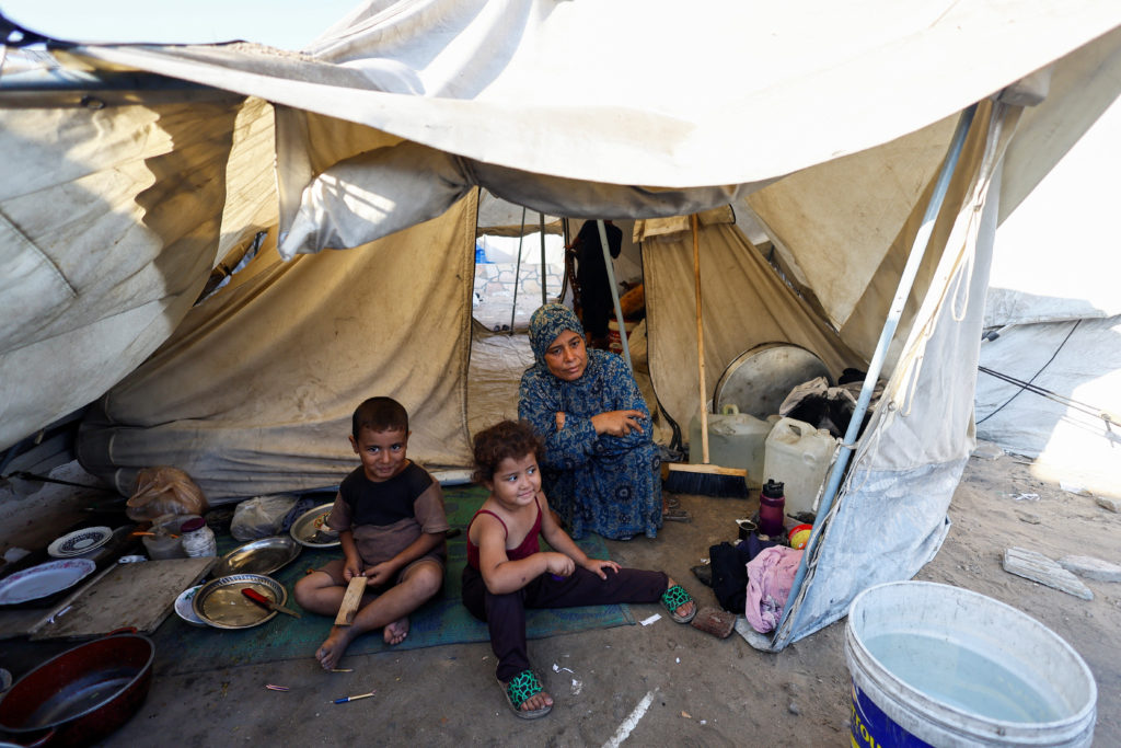 Palestinians displaced by the Israeli military offensive take shelter in a tent camp in Gaza City