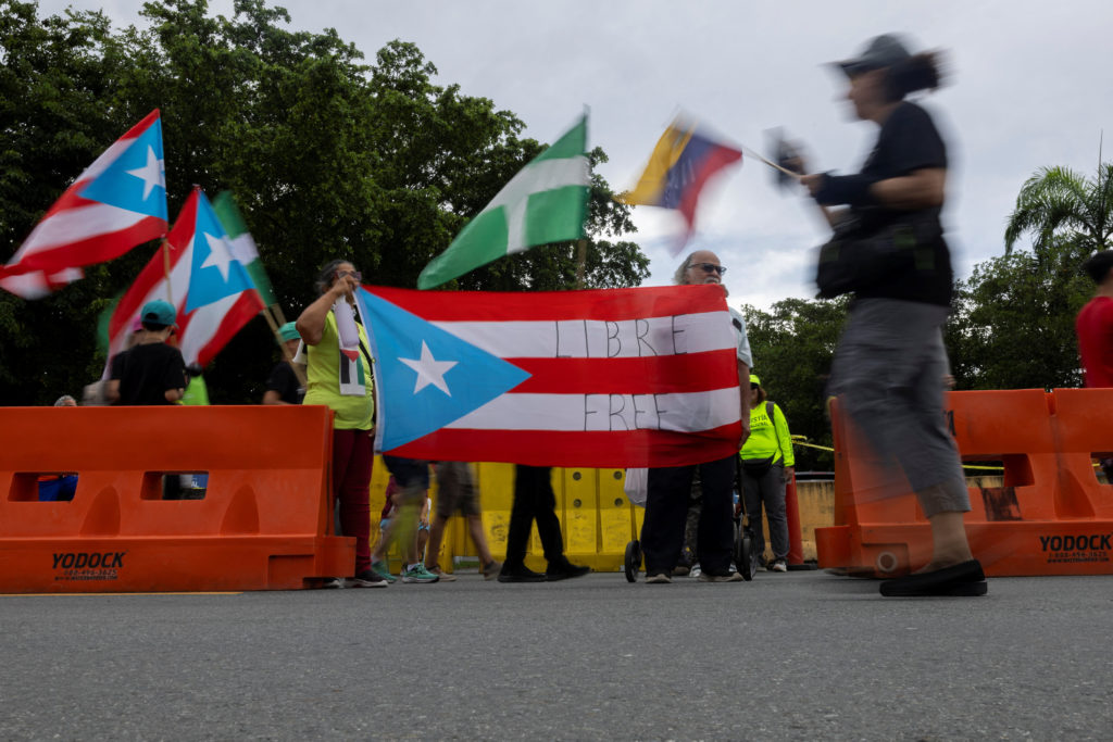 People rally against military exercises in front of the Muniz Puerto Rico Air National Guard Base, in Carolina