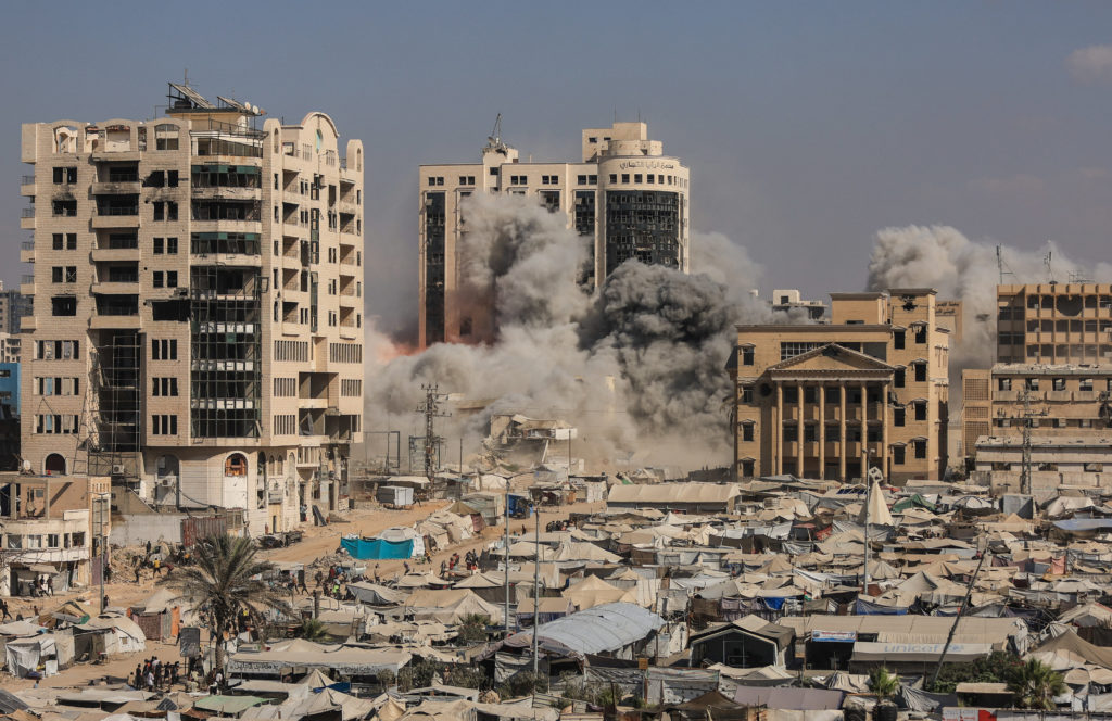 Smoke and flames rise as a residential building collapses after an Israeli air strike