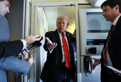 Trump speaks aboard Air Force One on his way to a state visit in Britain