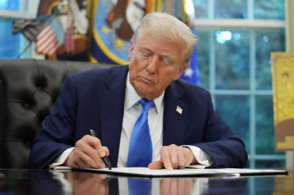 U.S. President Donald Trump signs executive orders in the Oval Office at the White House in Washington