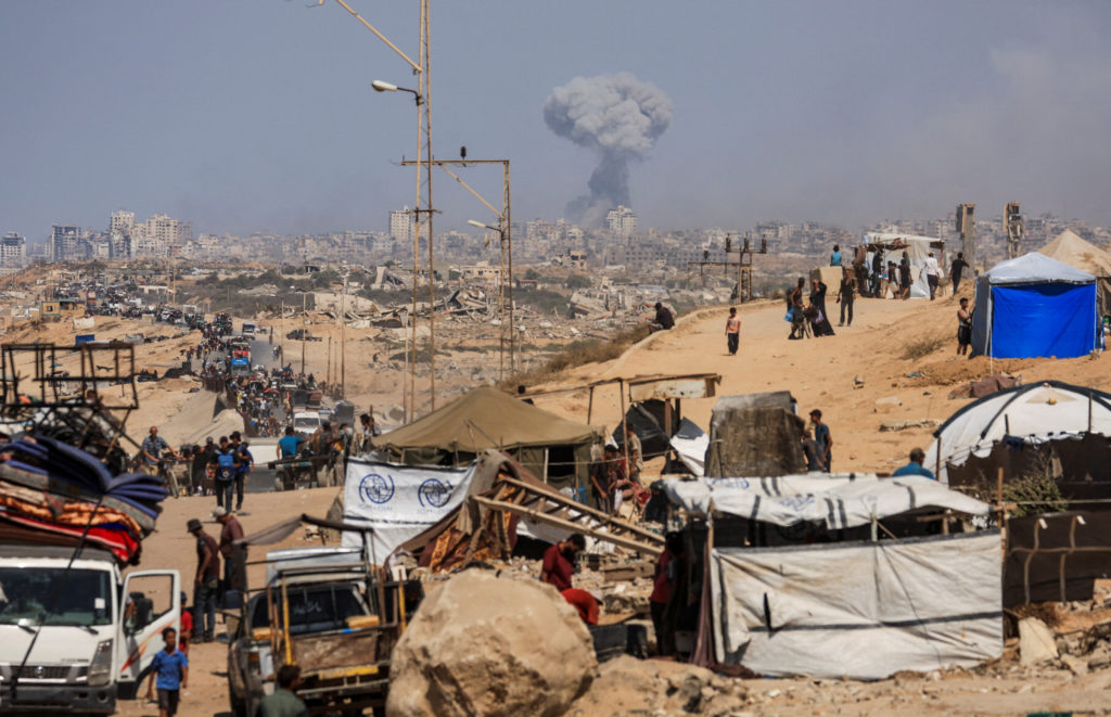 Displaced Palestinians flee southward in the central Gaza Strip after Israeli forces ordered residents of Gaza City to eva...