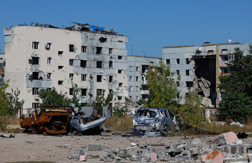 A view shows destroyed cars near damaged apartment buildings in Kurakhove