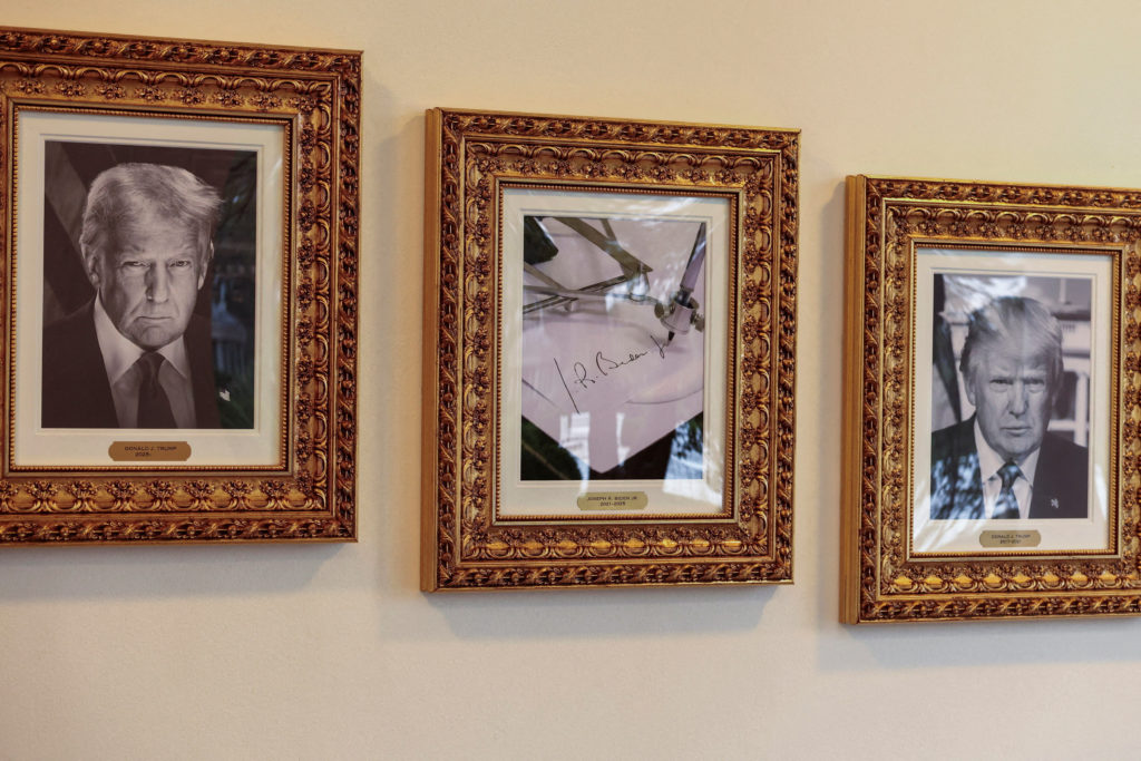 An image of an autopen signing former U.S. President Joe Biden's signature is displayed in place of a portrait Biden at th...