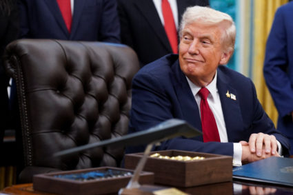 U.S. President Donald Trump signs an executive order in the Oval Office of the White House