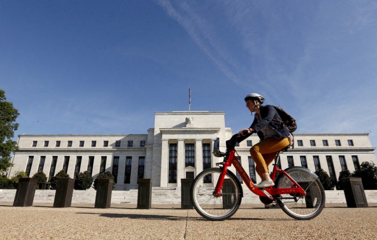 FILE PHOTO: Cyclist passes the Federal Reserve in Washington