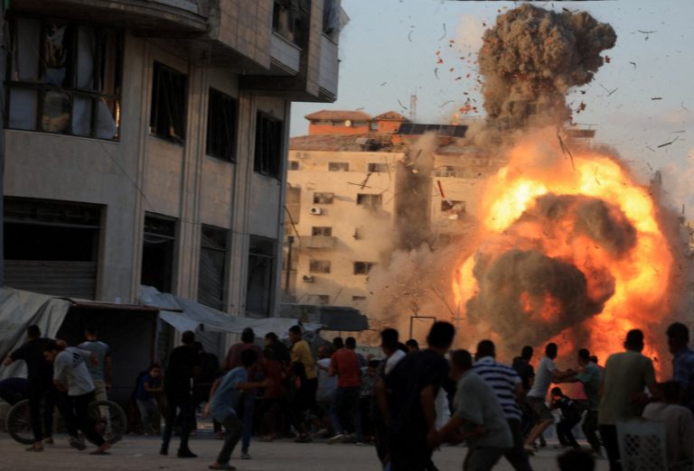 Smoke and flames rise as a residential building collapses after an Israeli air strike, in Gaza City
