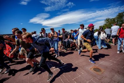 People run after a shot was fired at U.S. right-wing activist and commentator Charlie Kirk at a Utah Valley University spe...
