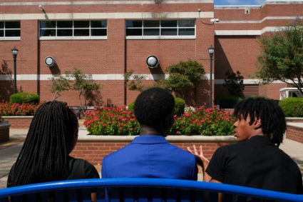 Students sit on a bench on the campus of HBCU Tennessee State University