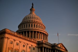 A U.S. flag is displayed near the U.S. Capitol building, in Washington
