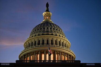 A U.S. flag flutters near the U.S. Capitol building, in Washington