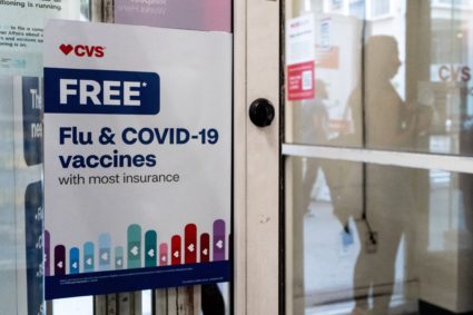 A sign advertises free flu and COVID-19 vaccinations at a CVS Pharmacy in New York City