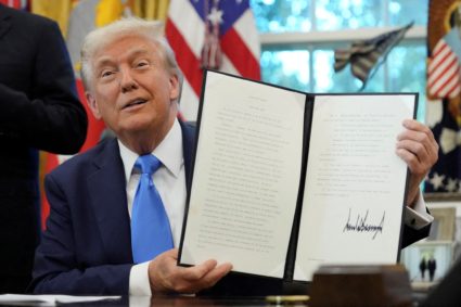 U.S. President Donald Trump signs executive orders in the Oval Office at the White House in Washington