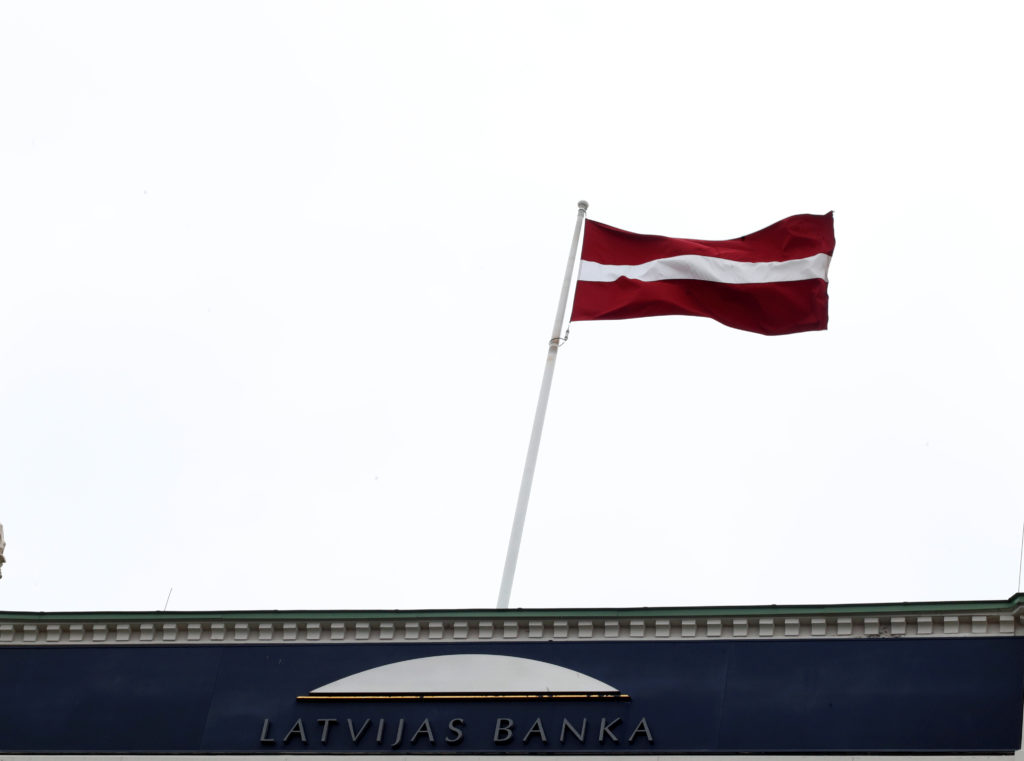 National flag flutters over Latvian central bank headquarters in Riga