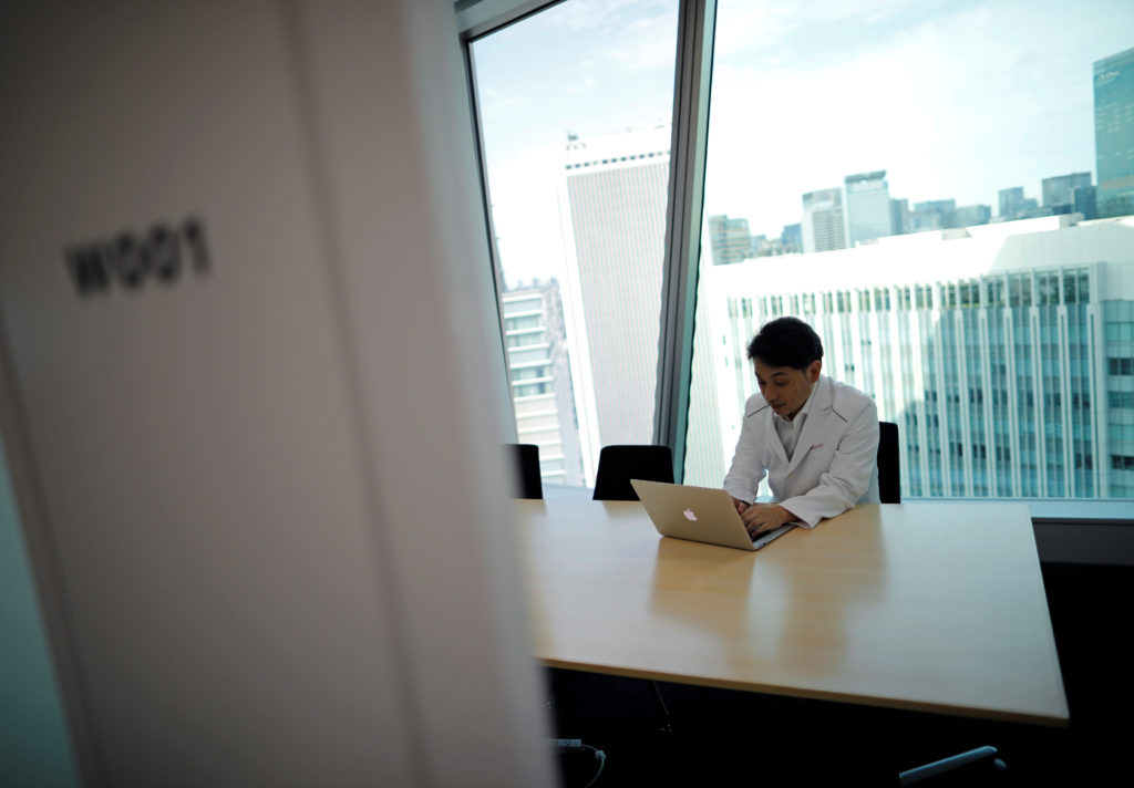 Medical doctor Makoto Kitada demonstrates a telemedicine application service called 'CLINICS', in Tokyo
