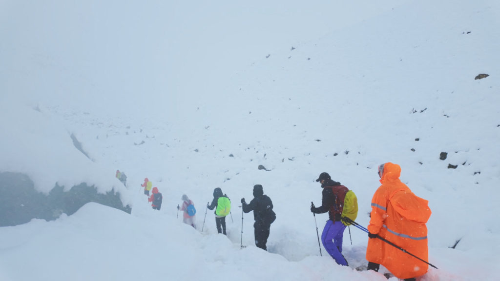 A screen capture from video shows trekkers leaving their campsite, as unusually heavy snow and rainfall pummeled the Himal...