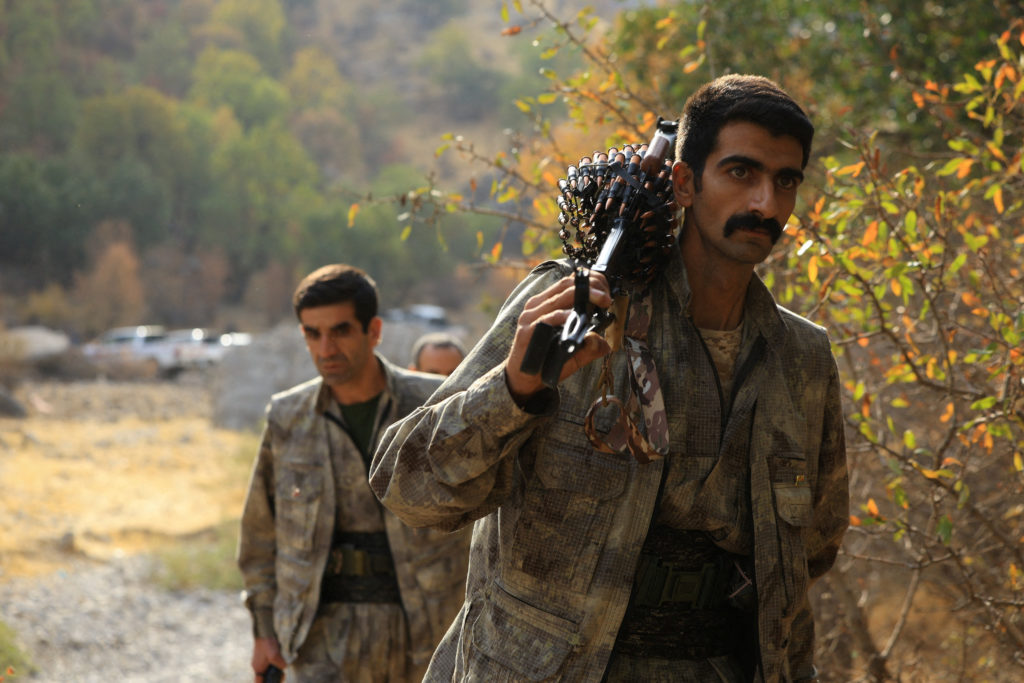 Fighters with the Kurdistan Workers' Party (PKK) walk for a disarmament ceremony in Qandil
