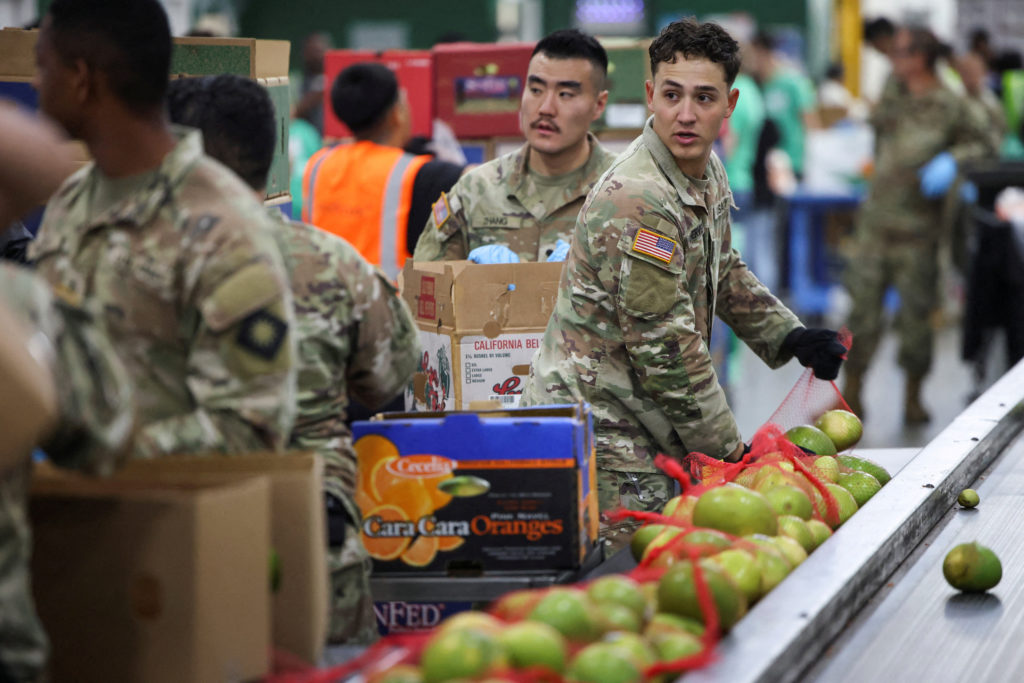 Members of the National Guard pack food at a Los Angeles Regional Food Bank facility