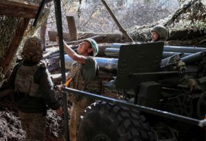 FILE PHOTO: Ukrainian servicemen fire a self-propelled howitzer towards Russian troops near the frontline town of Pokrovsk