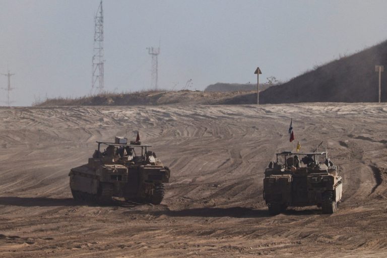 Israeli armoured personnel carriers (APC) manoeuvre on Israeli side of the Israel-Gaza border