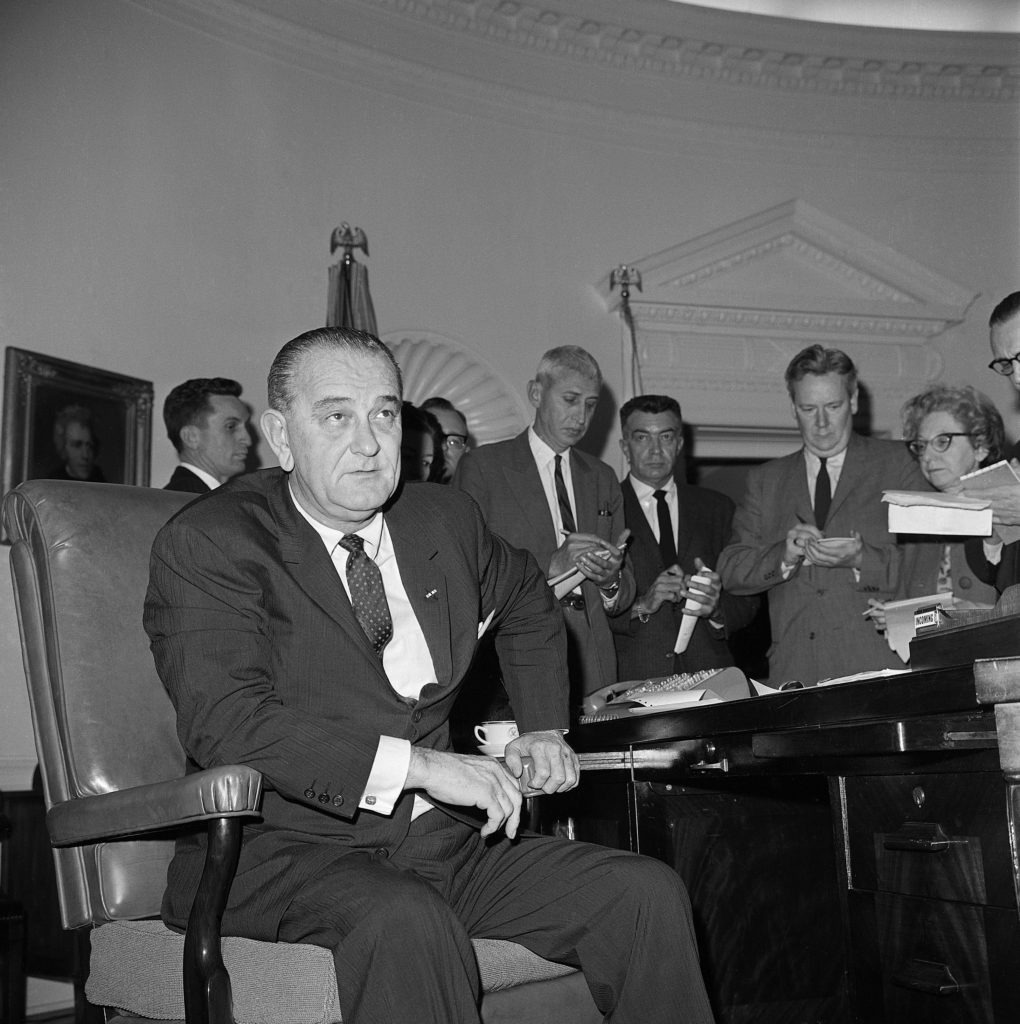 Lyndon Johnson Leans Forward at His Desk