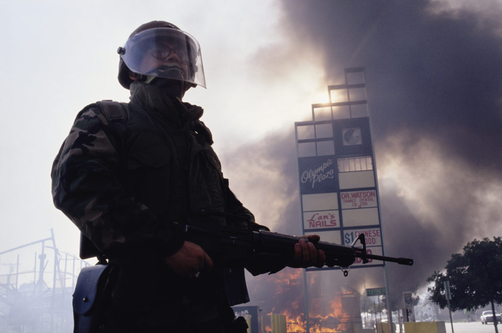 Guardsman Standing near Burning Building