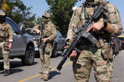 People protest during a standoff with ICE and federal officers in Chicago