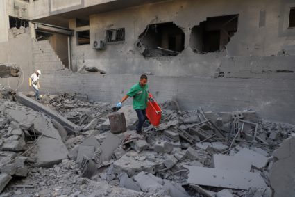 Palestinians inspect the damage at a residential neighborhood following an Israeli operation, in Gaza City