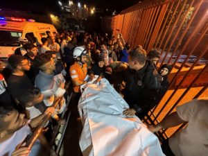 Palestinians carry a man, who according to medics was killed in an Israeli strike, at Nasser Hospital in Khan Younis