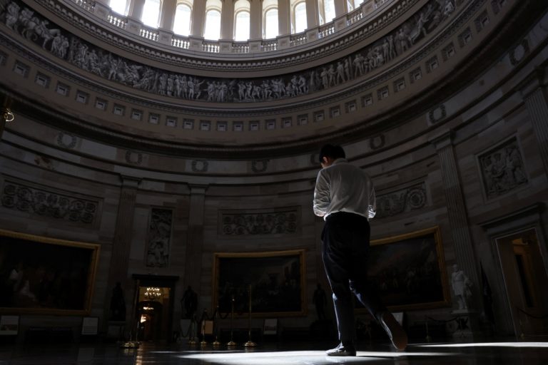 A man walks through the empty U.S. Capitol rotunda in Washington